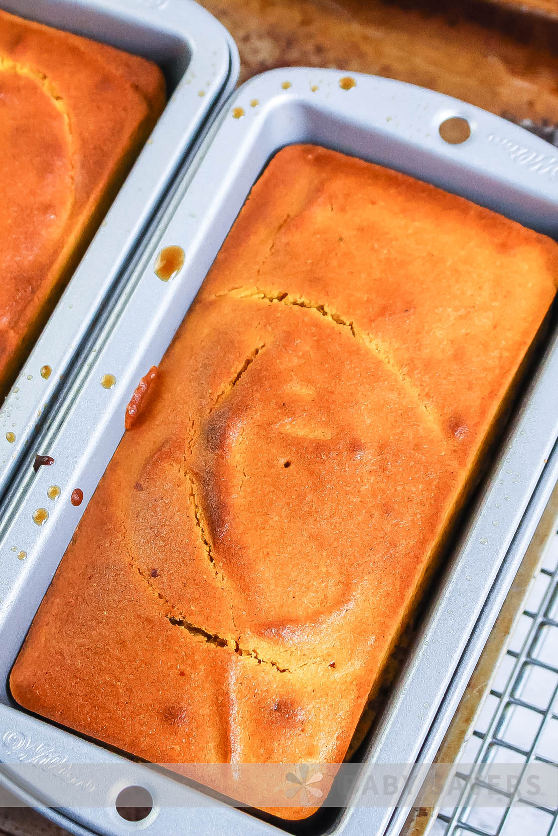 air fryer pumpkin bread recipe. Two loaves in a pan after baking