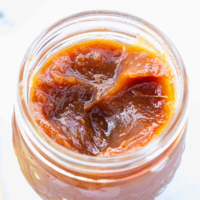 apple butter recipe with a small mason jar full of brown apple butter spread