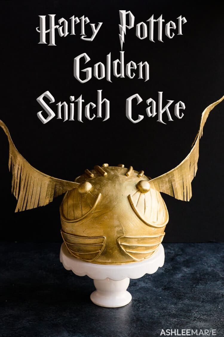 Harry Potter cake with a golden snitch from quidditch on top
