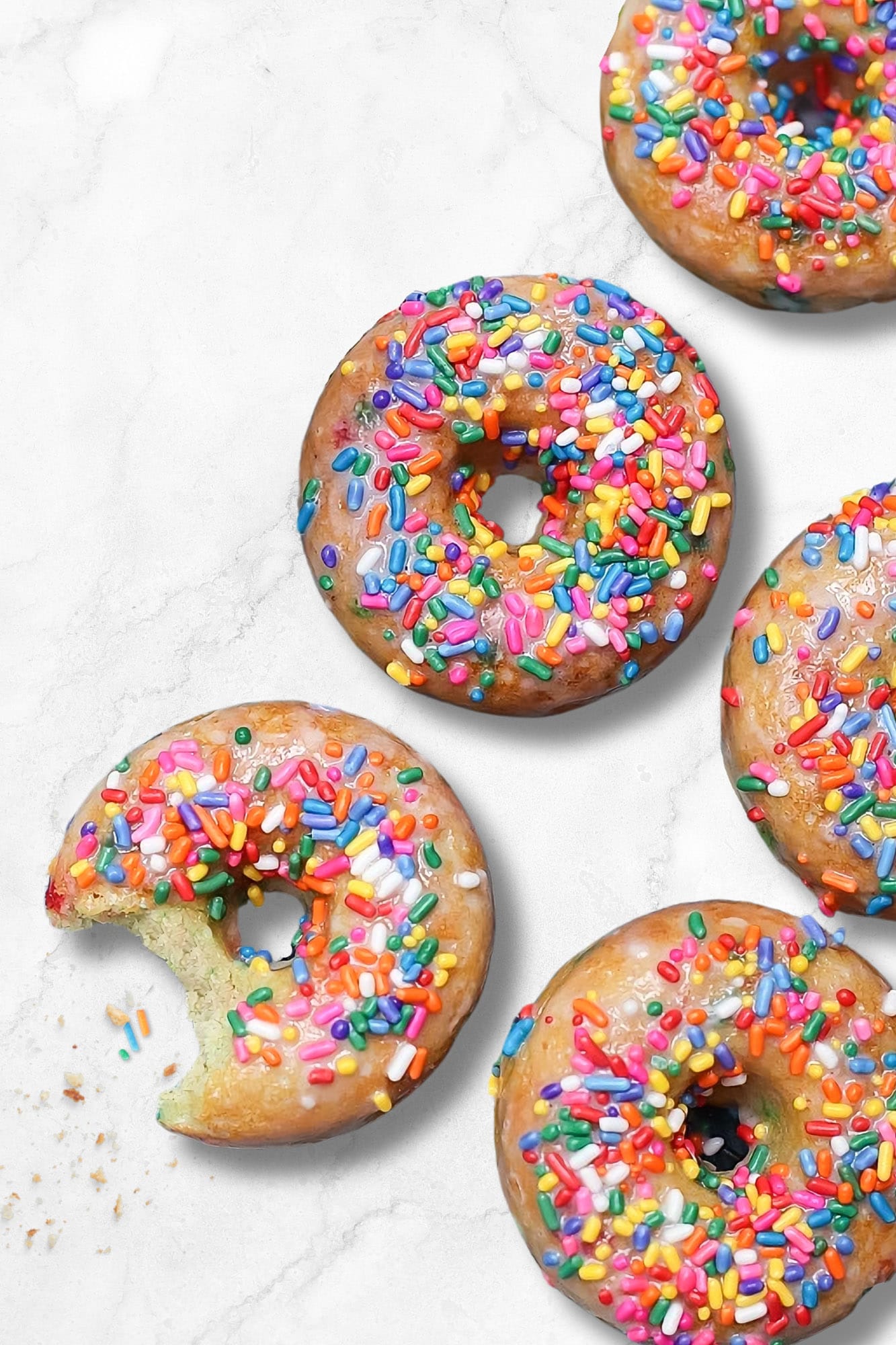 pancake mix donuts with sprinkles on a white marble background