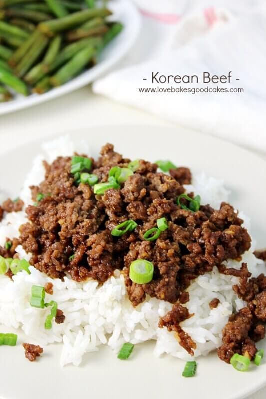 A plate of Korean beef served over white rice, garnished with green onions, with a side of green beans. This easy dinner idea is perfect for busy families. The text 