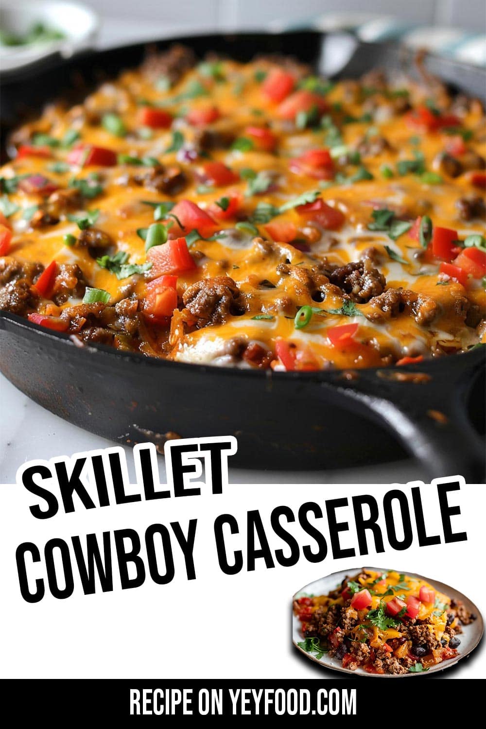 A skillet cowboy casserole with melted cheese, ground beef, beans, and diced vegetables, presented in a cast iron skillet. Perfect for busy families meals. Text overlay with the recipe source has also been added across the bottom.
